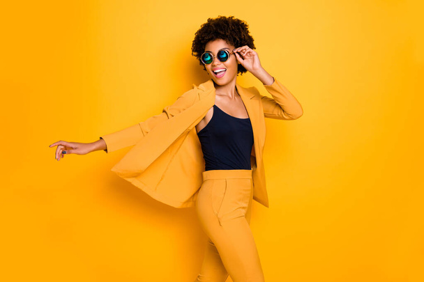 Profile side photo of positive cheerful afro american girl have rest relax look enjoy fall holidays wear fashionable vogue suit isolated over yellow color background - Foto, Imagem