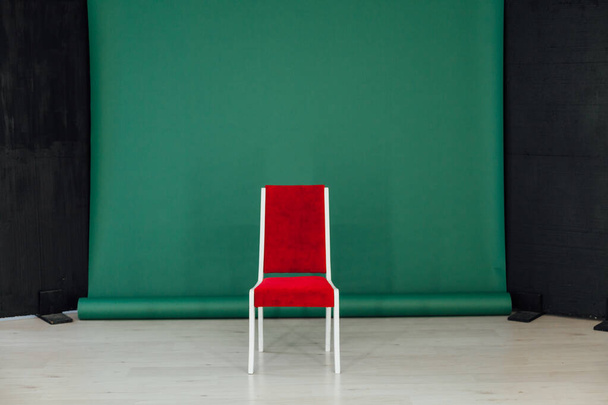 black green background in the interior of the room and a red chair - Zdjęcie, obraz