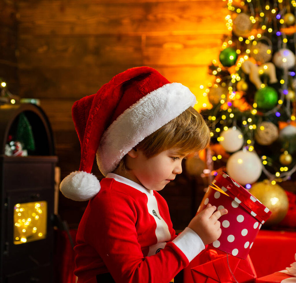 Little Santa Claus helper elf with a magic gift for Christmas. Family holiday. Merry christmas and happy new year. Check contents of christmas stocking. Holiday discounts. - Foto, Imagen