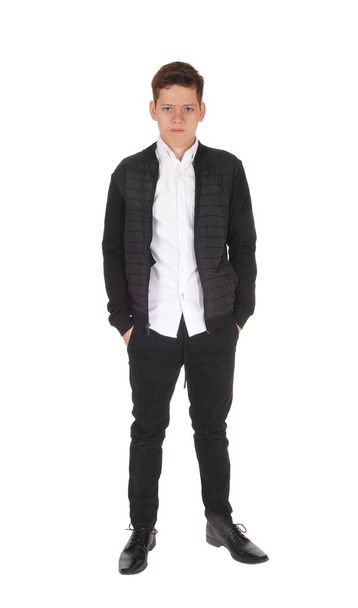Serious young teenager boy standing in the studio - Valokuva, kuva