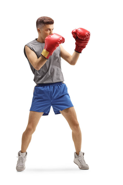 Young guy training boxing with red gloves - Zdjęcie, obraz