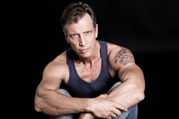 40-50 years old fit man with a vest looking at the camera - Photo, image