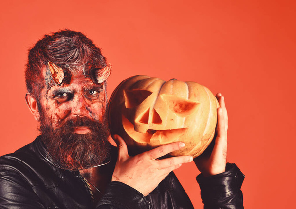 Devil or monster with October decorations. Man wearing scary makeup - Fotografie, Obrázek