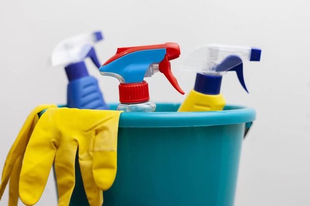 Cleaning concept. House work plastic accesories, man or woman in gloves with a plastic bottle of special spray for cleaning. Chemical detergent bottle. Keeping cleaning with detergents and washing it. - Foto, imagen
