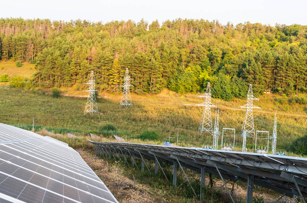 Solar panels on a background of power lines among the forest - Foto, immagini