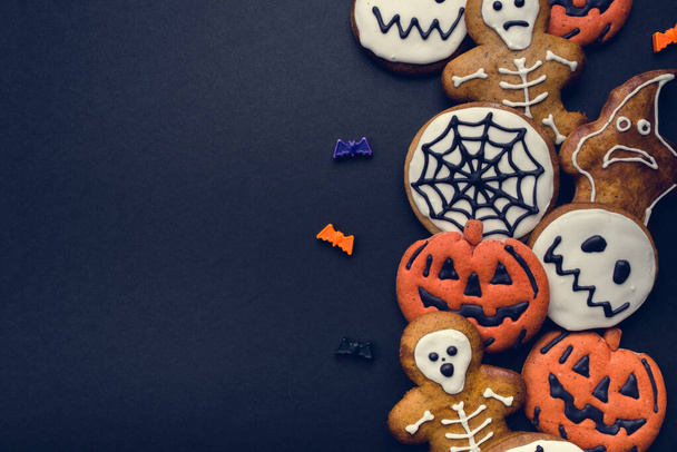 Halloween gingerbread cookies on black background. - Photo, image