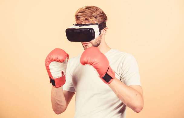 Cyber sportsman boxing gloves. Man play game in VR glasses. Cyber sport concept. Man boxer virtual reality headset simulation. Cyber coach online training. Explore cyber space. Augmented 3D world - Foto, immagini