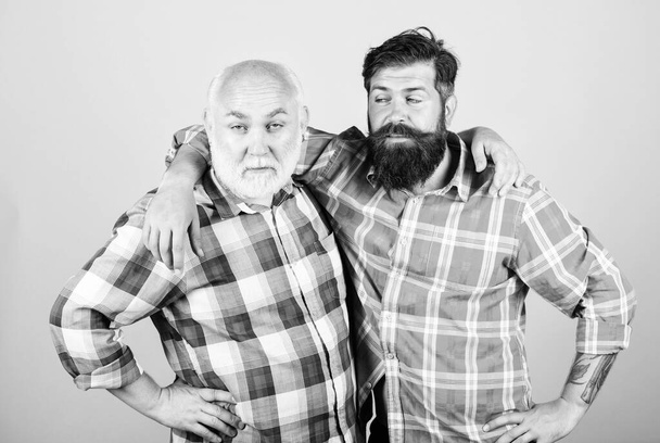 fellowship. father and son family. generational conflict. youth vs old age compare. retirement. male beard care. checkered fashion. barbershop and hairdresser salon. two bearded men senior and mature - Foto, imagen