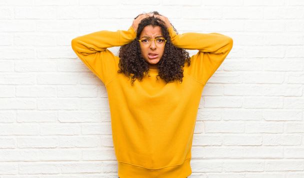 young black woman feeling frustrated and annoyed, sick and tired of failure, fed-up with dull, boring tasks against brick wall - Фото, изображение