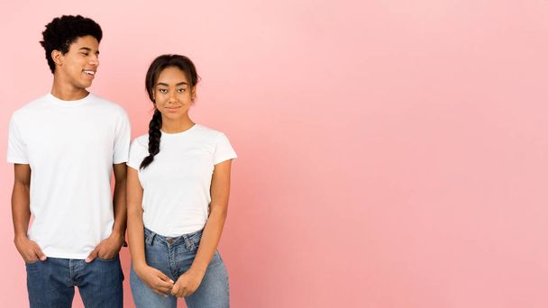 Young friends posing, guy looking at girl over pink background - Photo, Image