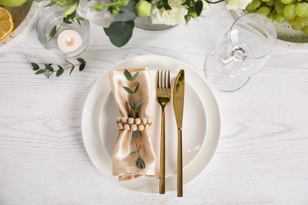 Elegant festive table setting on white wooden background, flat lay - Photo, Image