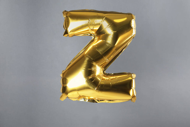 Golden letter Z balloon on grey background - Foto, imagen