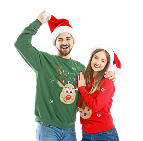 幸せな若いですカップルでクリスマス服上の白い背景 - 写真・画像