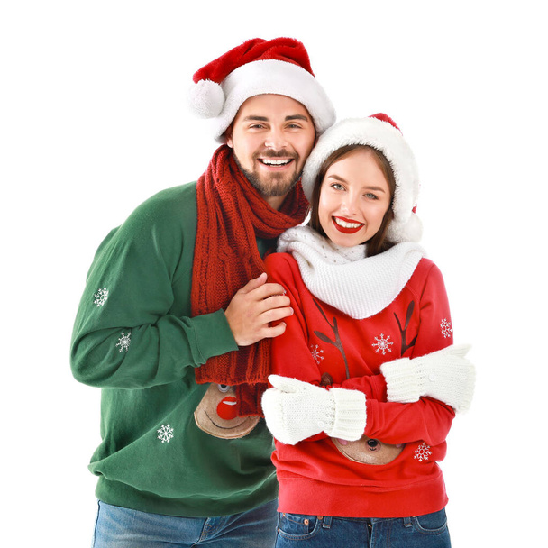 Happy young couple in Christmas clothes on white background - Foto, Bild