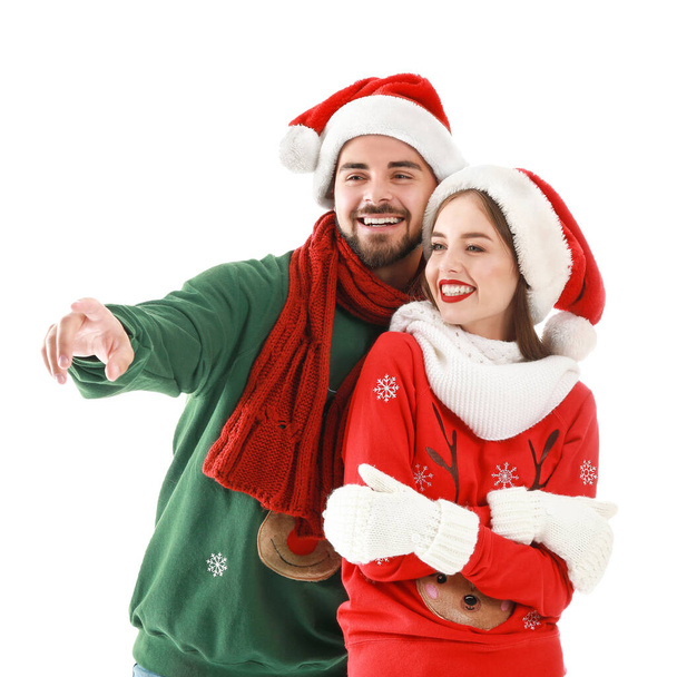 Happy young couple in Christmas clothes on white background - Foto, imagen