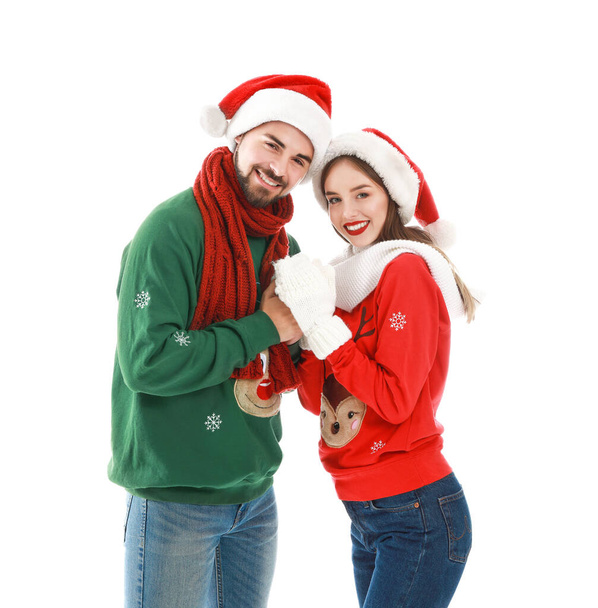 Happy young couple in Christmas clothes on white background - Fotografie, Obrázek