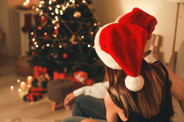 Happy young couple celebrating Christmas at home - Photo, image