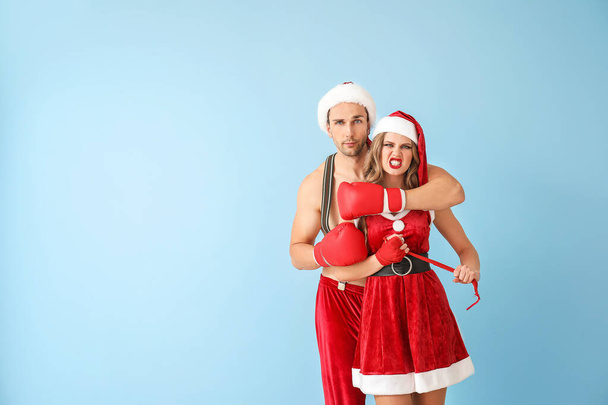 Young boxers dressed as Santa Claus on color background - 写真・画像