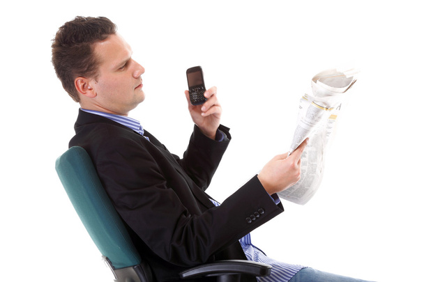 man reads newspaper phoning - economy news - Foto, Imagem