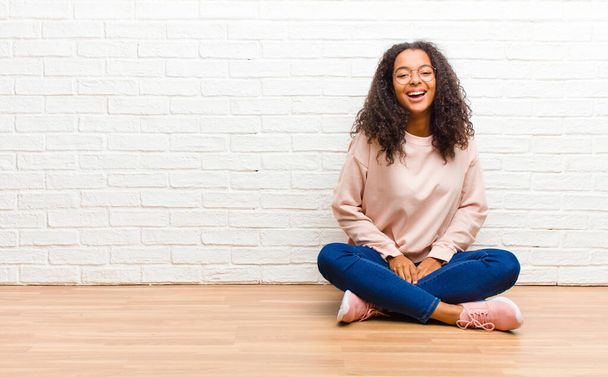 young african american black woman with a big, friendly, carefree smile, looking positive, relaxed and happy, chilling - 写真・画像