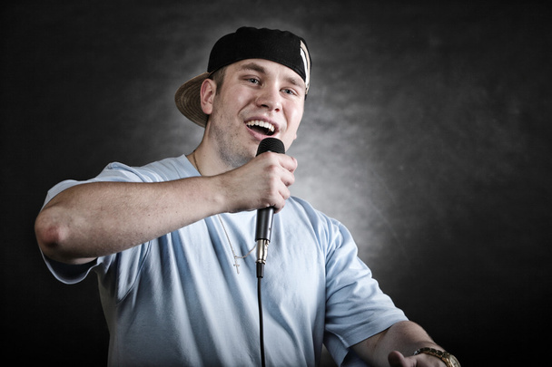 Rap singer man with microphone cool hand gesture - Fotó, kép
