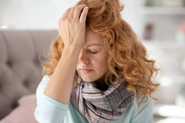 Curly young woman wearing scarf feeling sick and tired - Foto, immagini