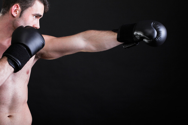 Portrait sportsman boxer in studio dark background - Фото, изображение