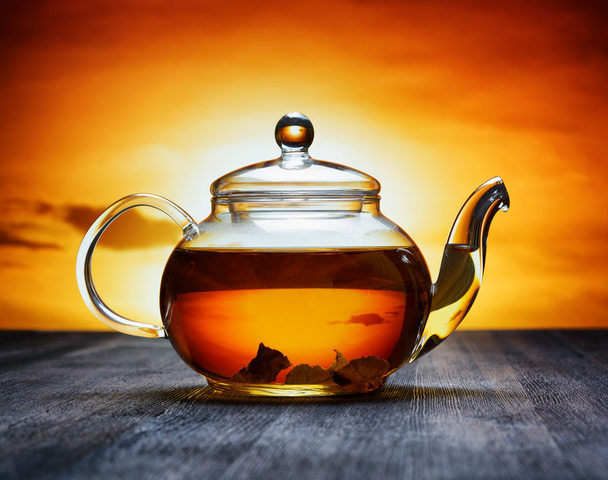 Teapot of fresh tea on sky background - Foto, Imagen
