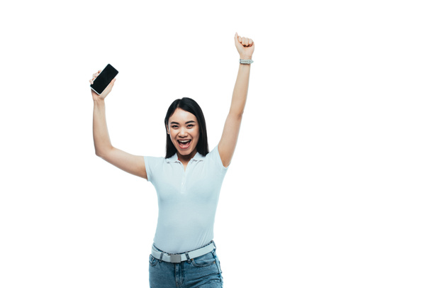 glücklich brünette asiatische Frau hält Smartphone mit leerem Bildschirm isoliert auf weiß - Foto, Bild