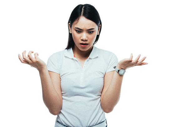 shocked attractive asian girl showing shrug gesture isolated on white - 写真・画像