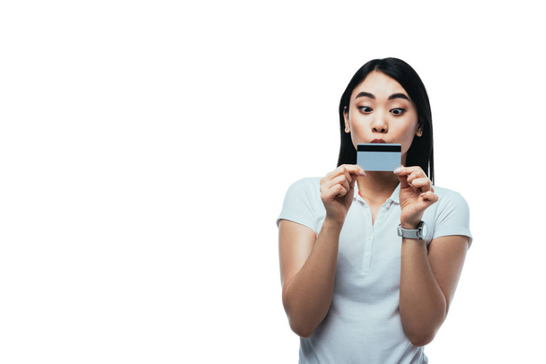 Ασιάτισσα φιλάει πιστωτική κάρτα που απομονώνεται σε λευκό - Φωτογραφία, εικόνα