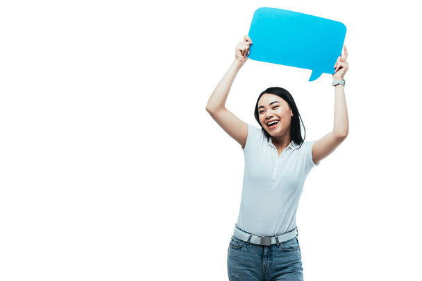 happy asian girl holding blue blank speech bubble isolated on white - Foto, Imagen
