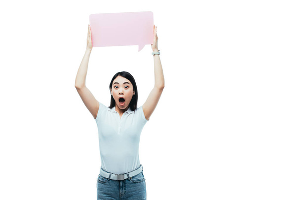 shocked asian girl holding pink blank speech bubble isolated on white - Zdjęcie, obraz