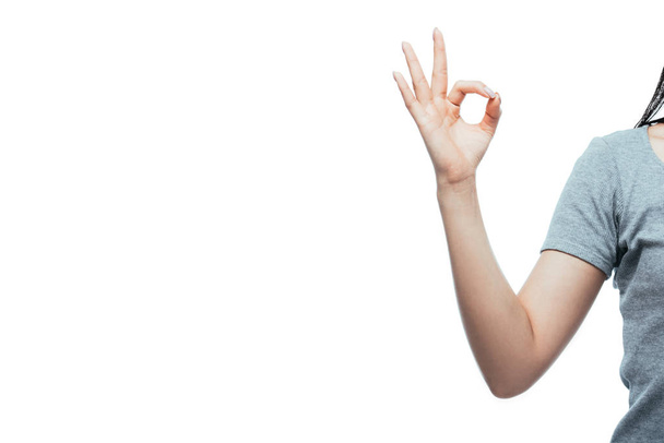 cropped view of girl showing ok sign isolated on white - Foto, afbeelding