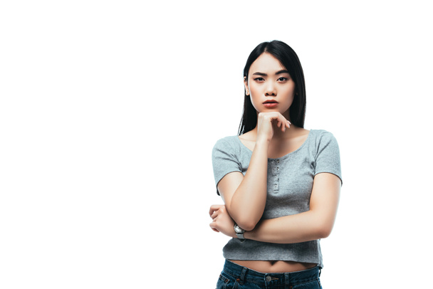 displeased asian girl looking at camera isolated on white - Photo, Image