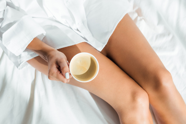 cropped view of woman holding cup of coffee at morning  - Photo, image