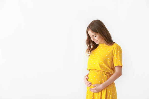 Beautiful pregnant woman on light background - Foto, Imagem