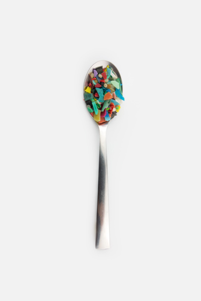 Spoon full of microplastics. Plastic pollution concept. - Photo, Image