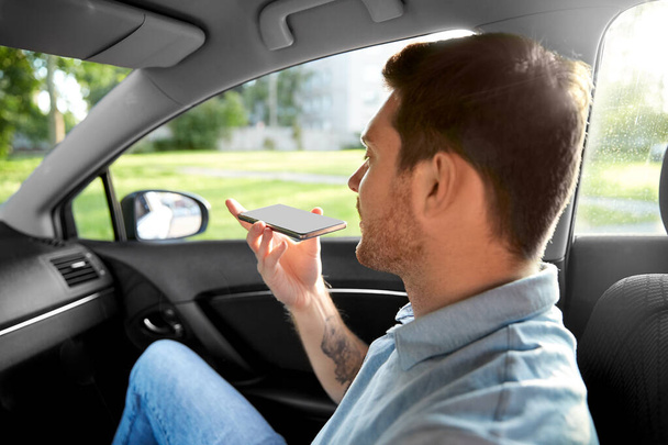 passenger recording voice on smartphone in car - Foto, Bild