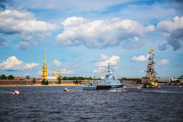 Warship of gray color on a pier in the city against the blue sky - Fotó, kép