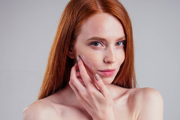 fashion portrait of redhead model nude with perfect skin studio on white background. - Фото, зображення