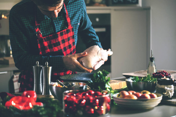 young man preparing delicious and healthy food in the home kitchen for christmas   - Fotoğraf, Görsel