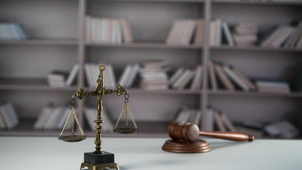 Still life of Law and Justice symbols on wooden table with blurred books background. - Photo, Image