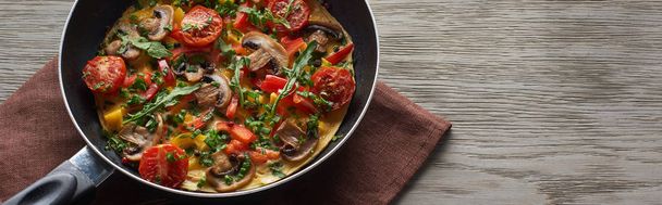 delicious homemade omelet with vegetables and greens in frying pan with napkin - Fotoğraf, Görsel