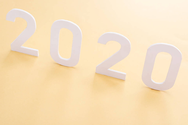 paper white 2020 numbers on yellow background - Foto, Imagen