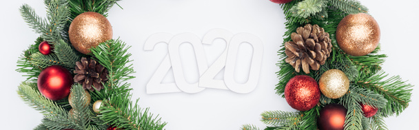 top view of 2020 numbers in Christmas tree wreath on white background, panoramic shot - Photo, Image