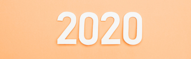 top view of white 2020 numbers on orange background, panoramic shot - Foto, Imagen