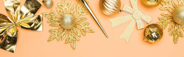 top view of festive golden christmas decoration on orange background, panoramic shot - Photo, image