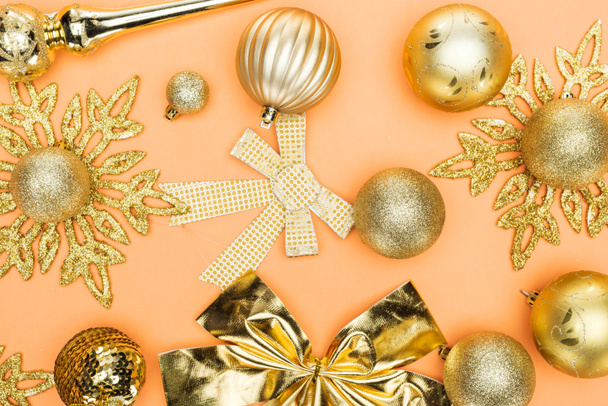 top view of golden christmas decoration on orange background - Photo, image
