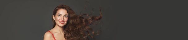 Perfect model woman with blowing hair. Pretty face, curly hairstyle - 写真・画像
